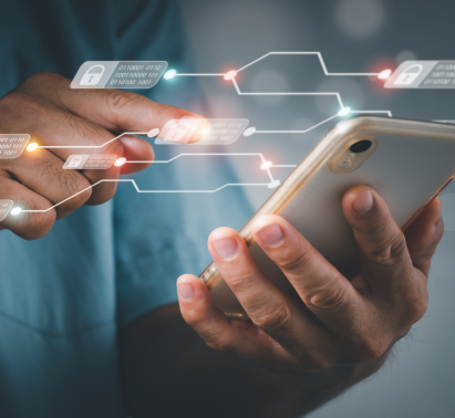A person holds a mobile phone with technology and security icons